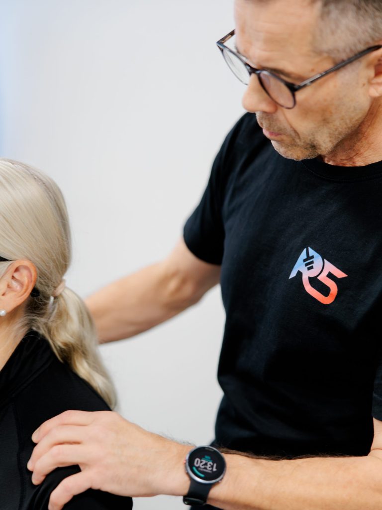 Osteopath Jerry Ketola treating the shoulder of a client at the clinic