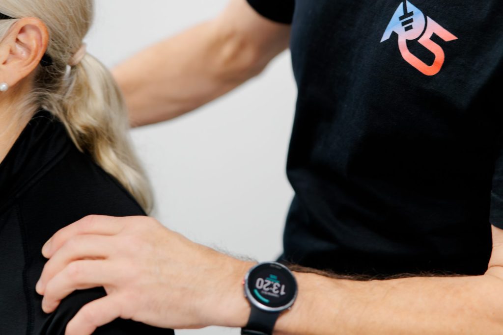 Osteopath Jerry Ketola placing a hand on the shoulder of a client during treatment